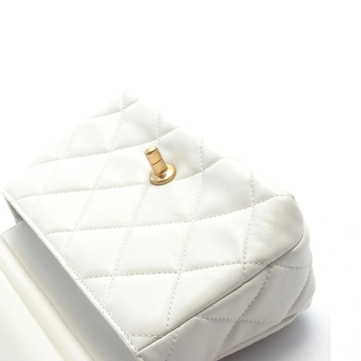 Chanel mini flap bag in white with quilted leather, decorated with pearls and gold hardware, showcasing elegant handbag design.