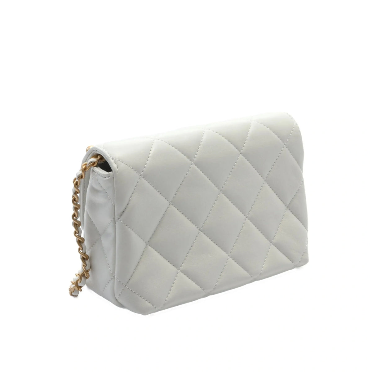 Chanel mini flap bag in white leather with pearl accents and gold hardware, featuring a classic rectangular shape and chain strap.
