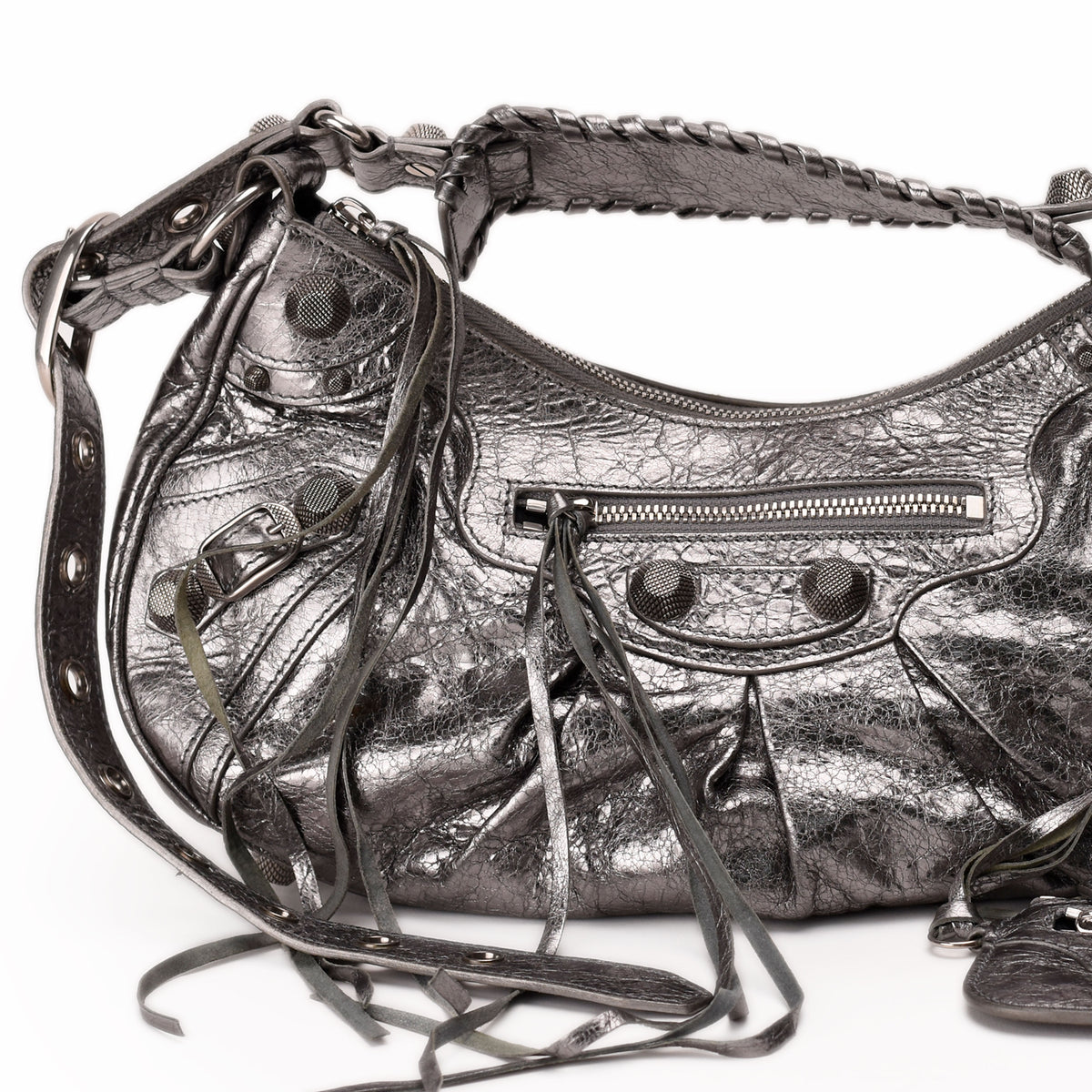Metallic silver leather handbag with studs, tassels, and braided handle. curated Pre-loved Luxury by Myluxe in Helsinki.