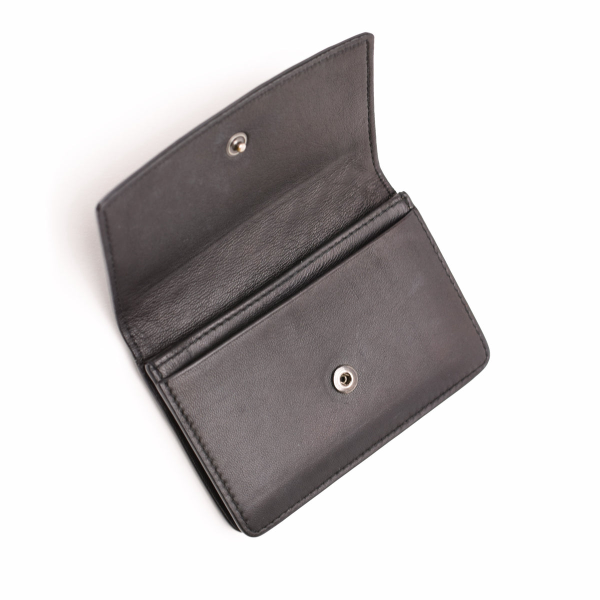 Black grained leather bi-fold wallet with silver snap closure, curated Pre-loved Luxury by Myluxe in Helsinki.