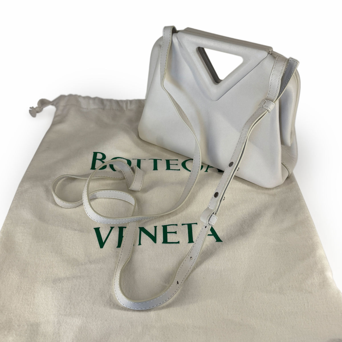 White leather Bottega Veneta handbag with a geometric handle and matching dust bag, curated Pre-loved Luxury by Myluxe in Helsinki.