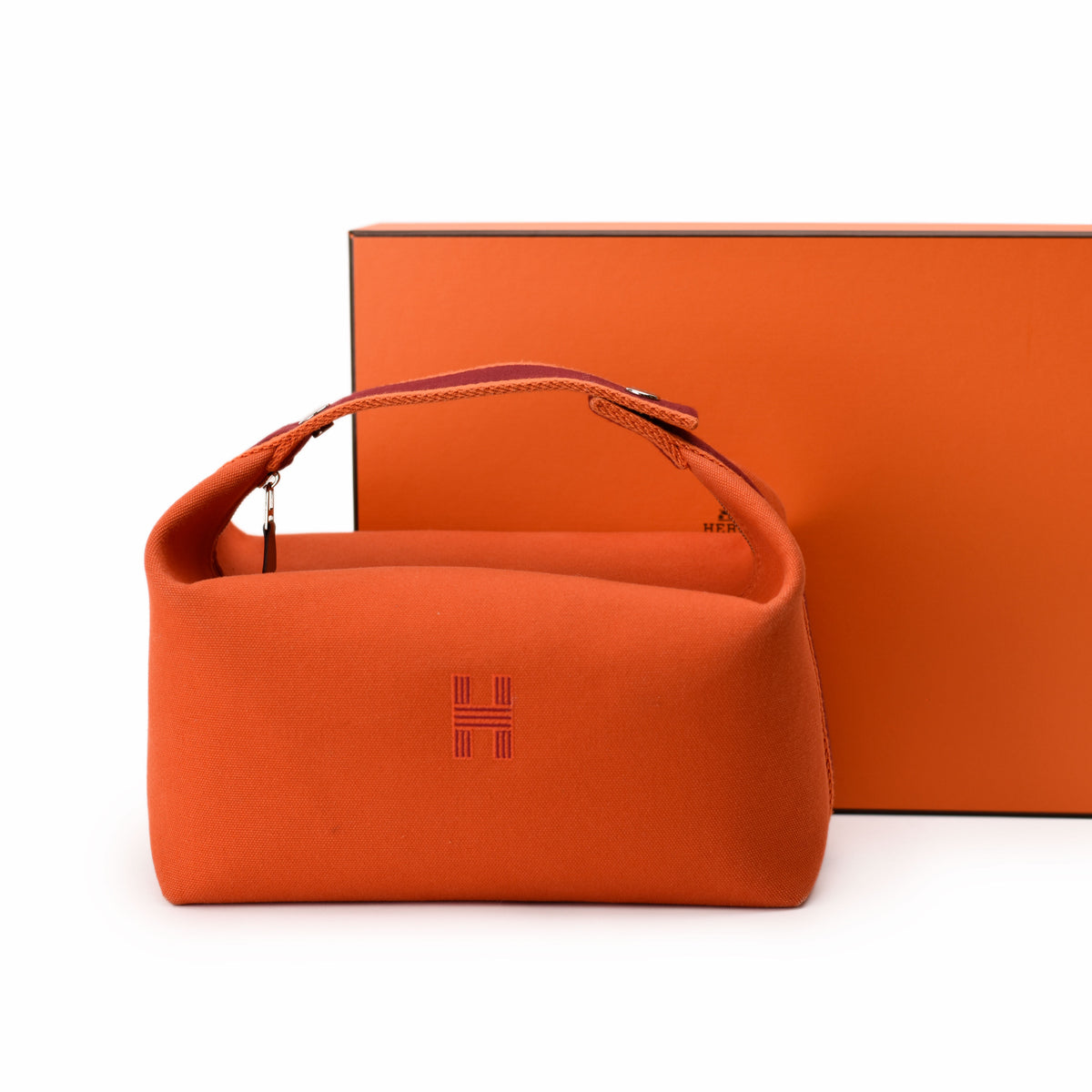 Orange Hermès leather handbag with top handle. curated Pre-loved Luxury by Myluxe in Helsinki.