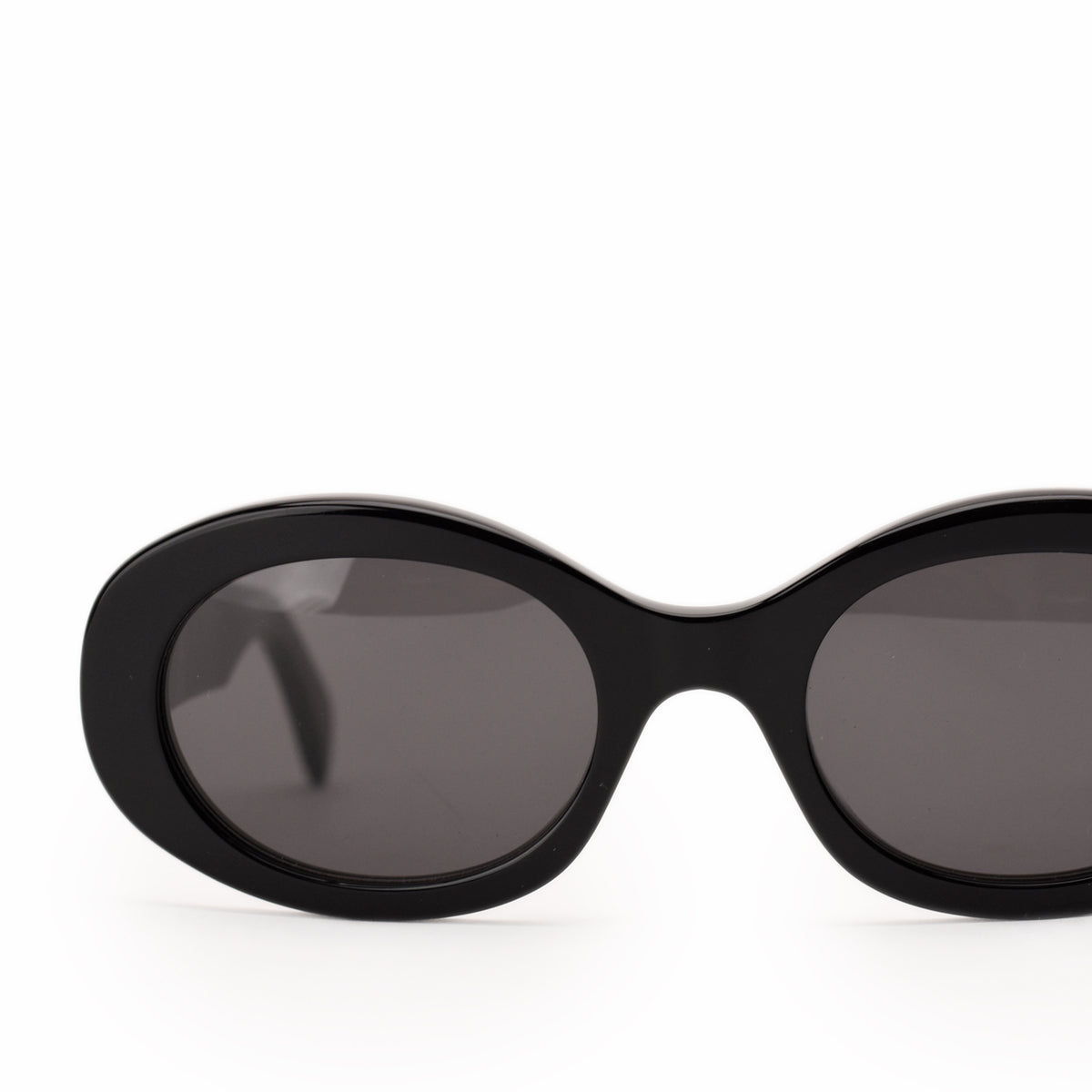 Black oval-shaped luxury sunglasses with dark tinted lenses, curated Pre-loved Luxury by Myluxe in Helsinki.