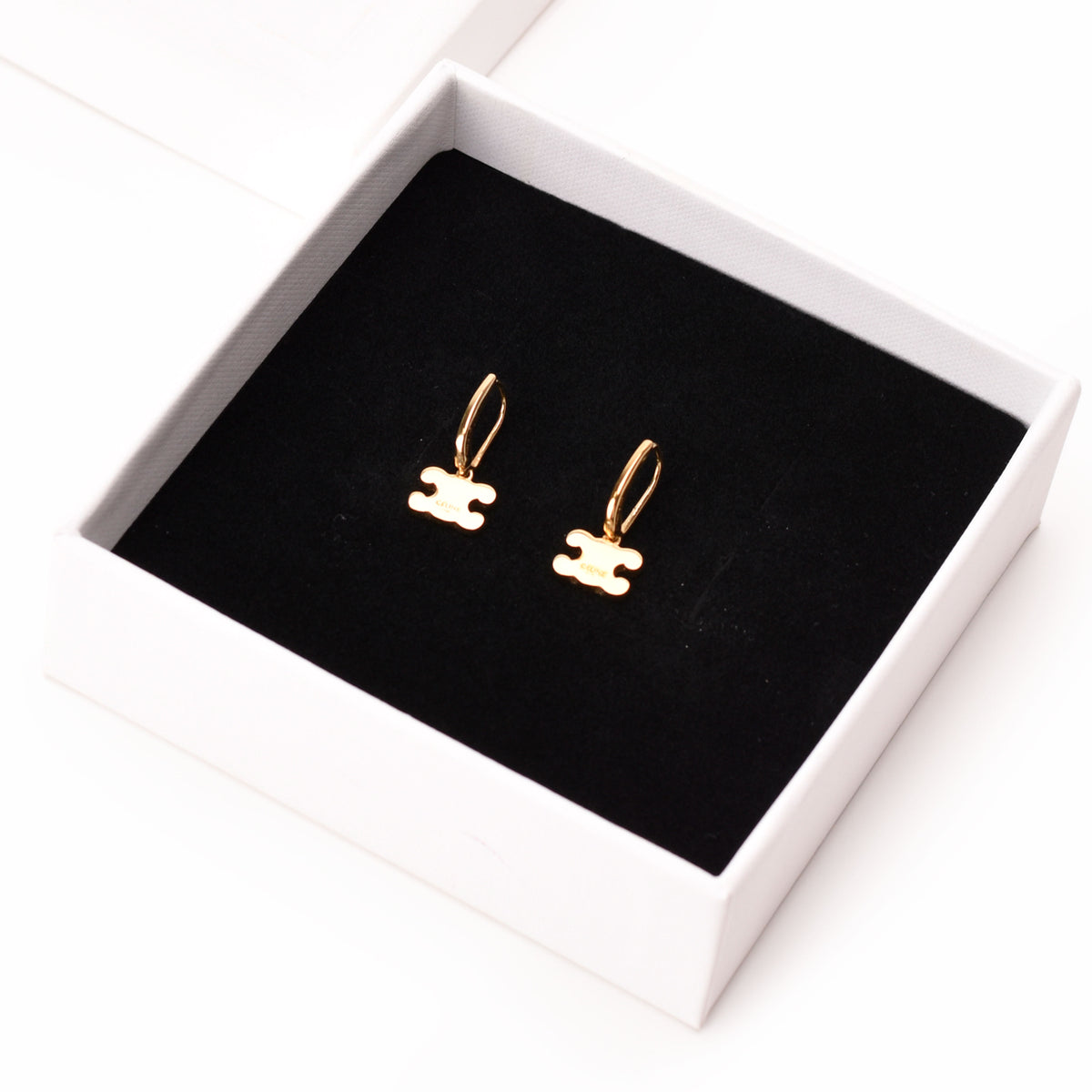 Gold Chanel earrings in a white gift box. curated Pre-loved Luxury by Myluxe in Helsinki.