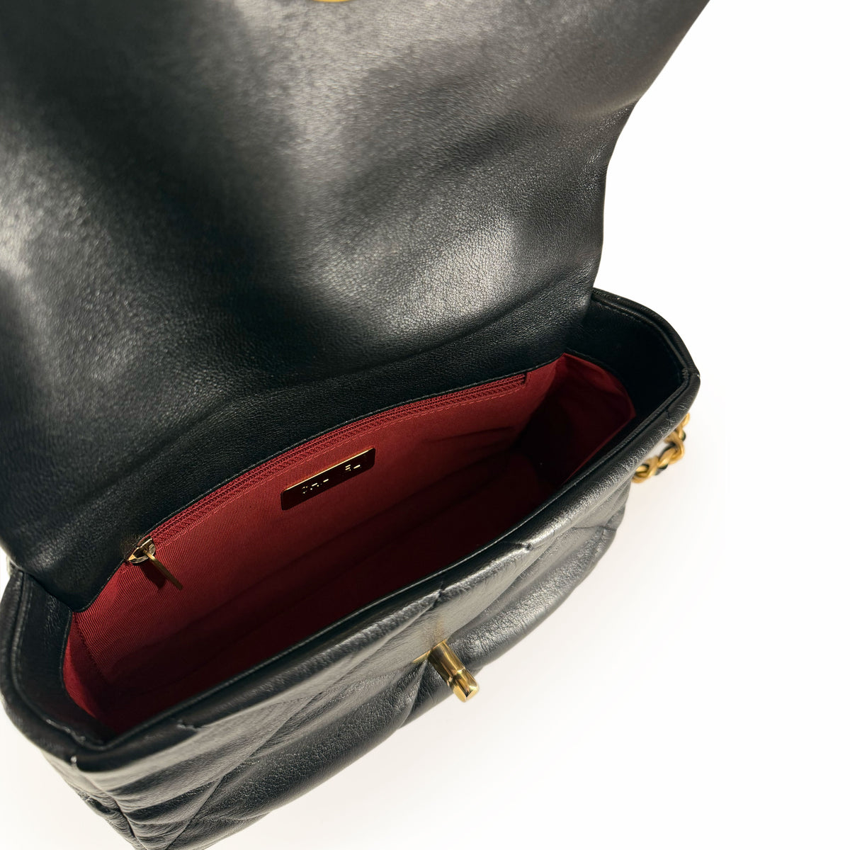 Black quilted leather handbag with red interior lining, curated Pre-loved Luxury by Myluxe in Helsinki.
