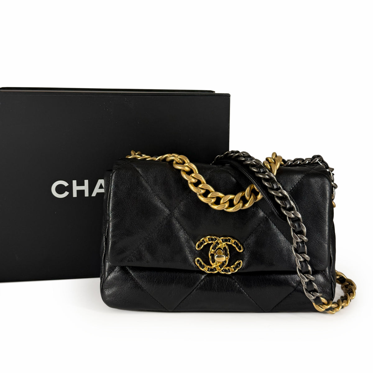Black quilted lambskin Chanel handbag with gold-tone chain strap, curated Pre-loved Luxury by Myluxe in Helsinki.