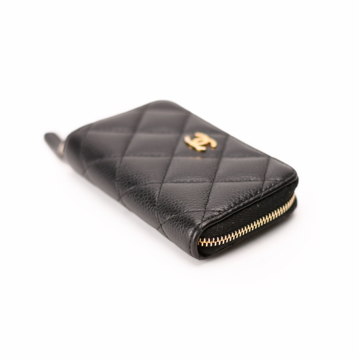 Black quilted caviar leather Chanel zip-around wallet with gold hardware. curated Pre-loved Luxury by Myluxe in Helsinki.