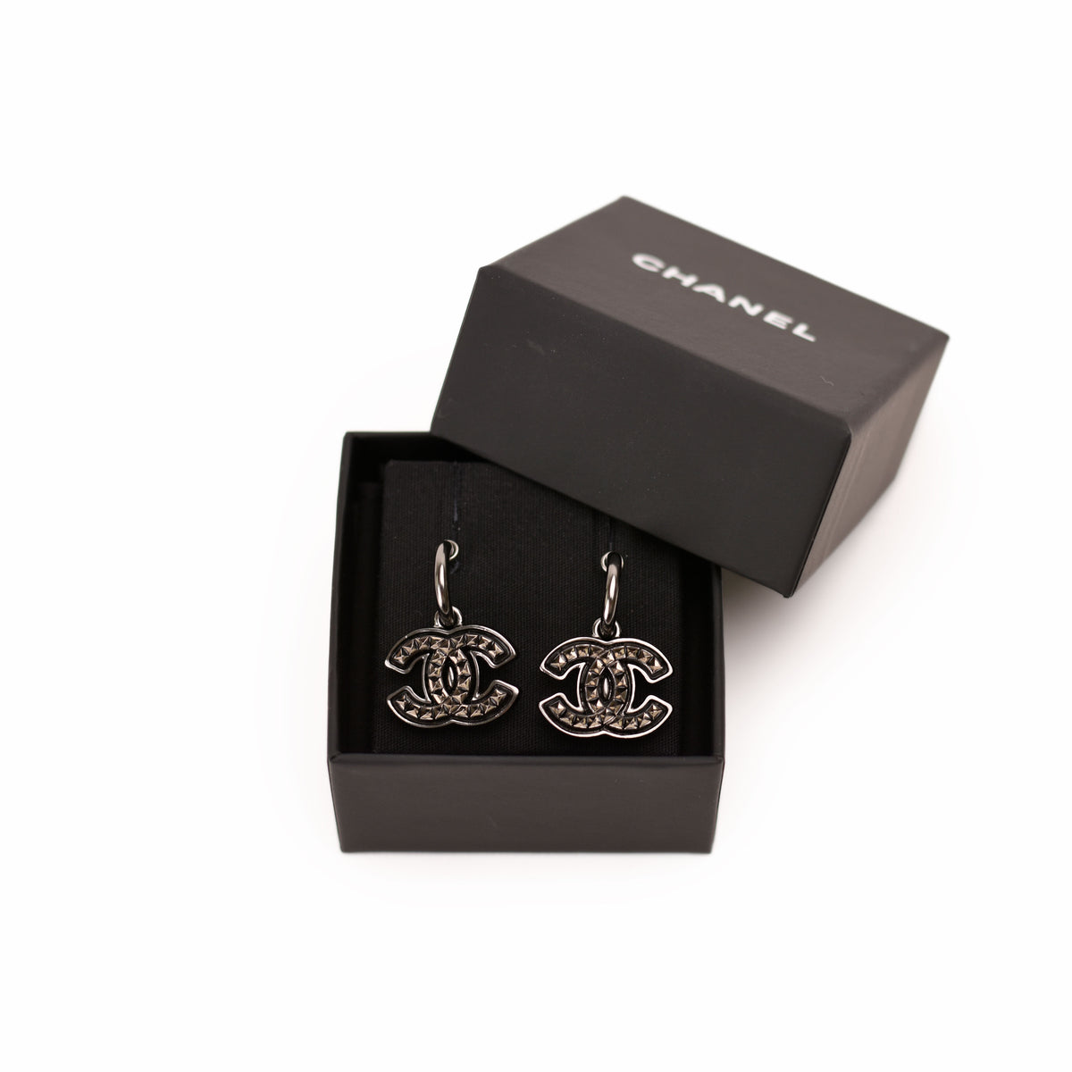Chanel silver-tone interlocking CC logo earrings with sparkling crystals. Curated Pre-loved Luxury by Myluxe in Helsinki.