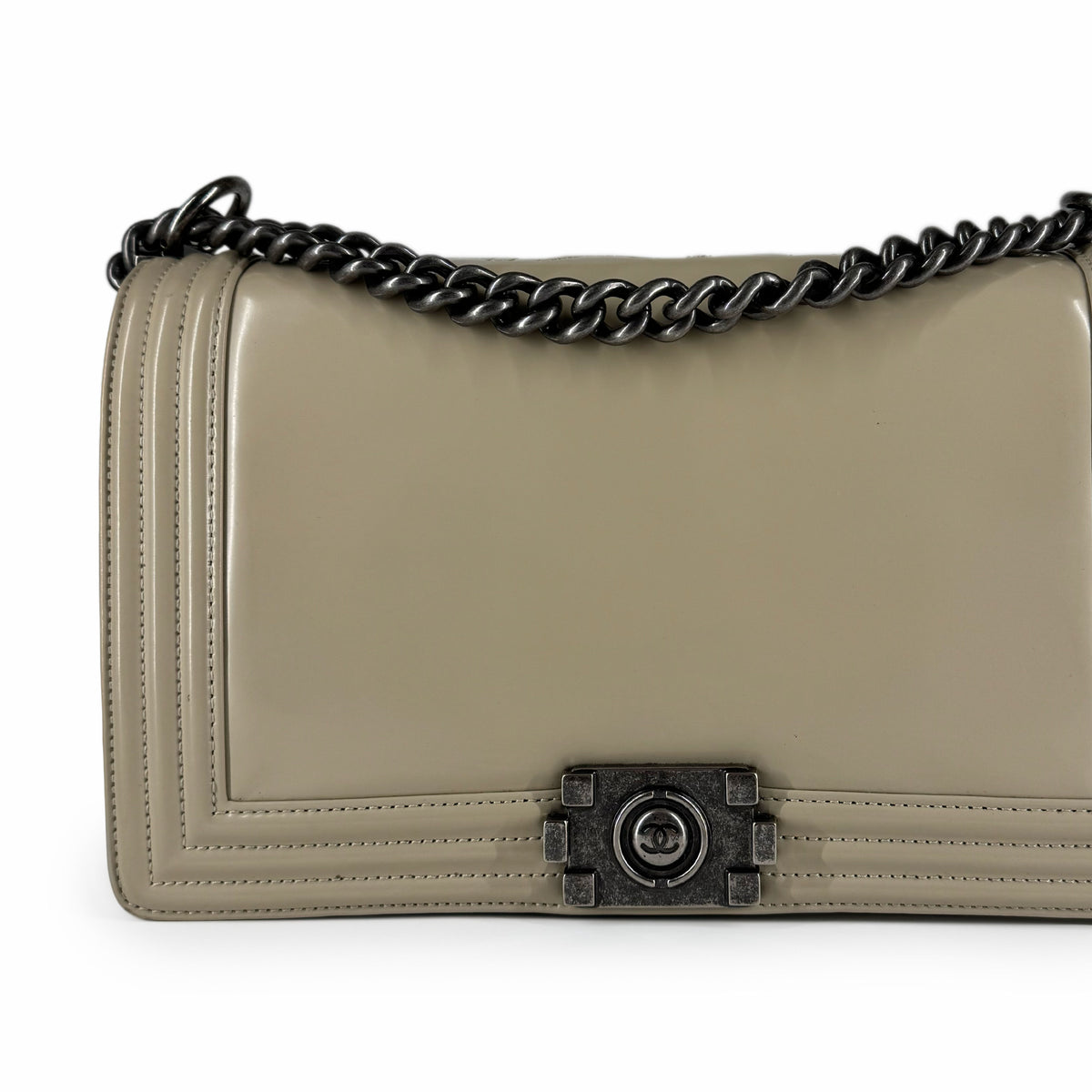 Beige leather flap handbag with dark metal chain strap and logo clasp, curated Pre-loved Luxury by Myluxe in Helsinki.