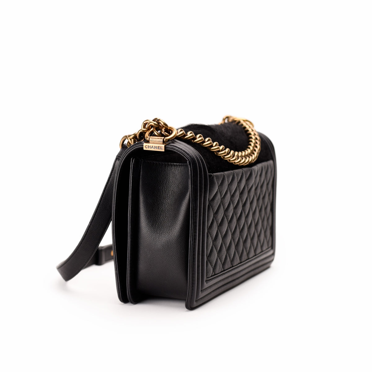 Black quilted leather Chanel handbag with gold chain strap, curated Pre-loved Luxury by Myluxe in Helsinki.