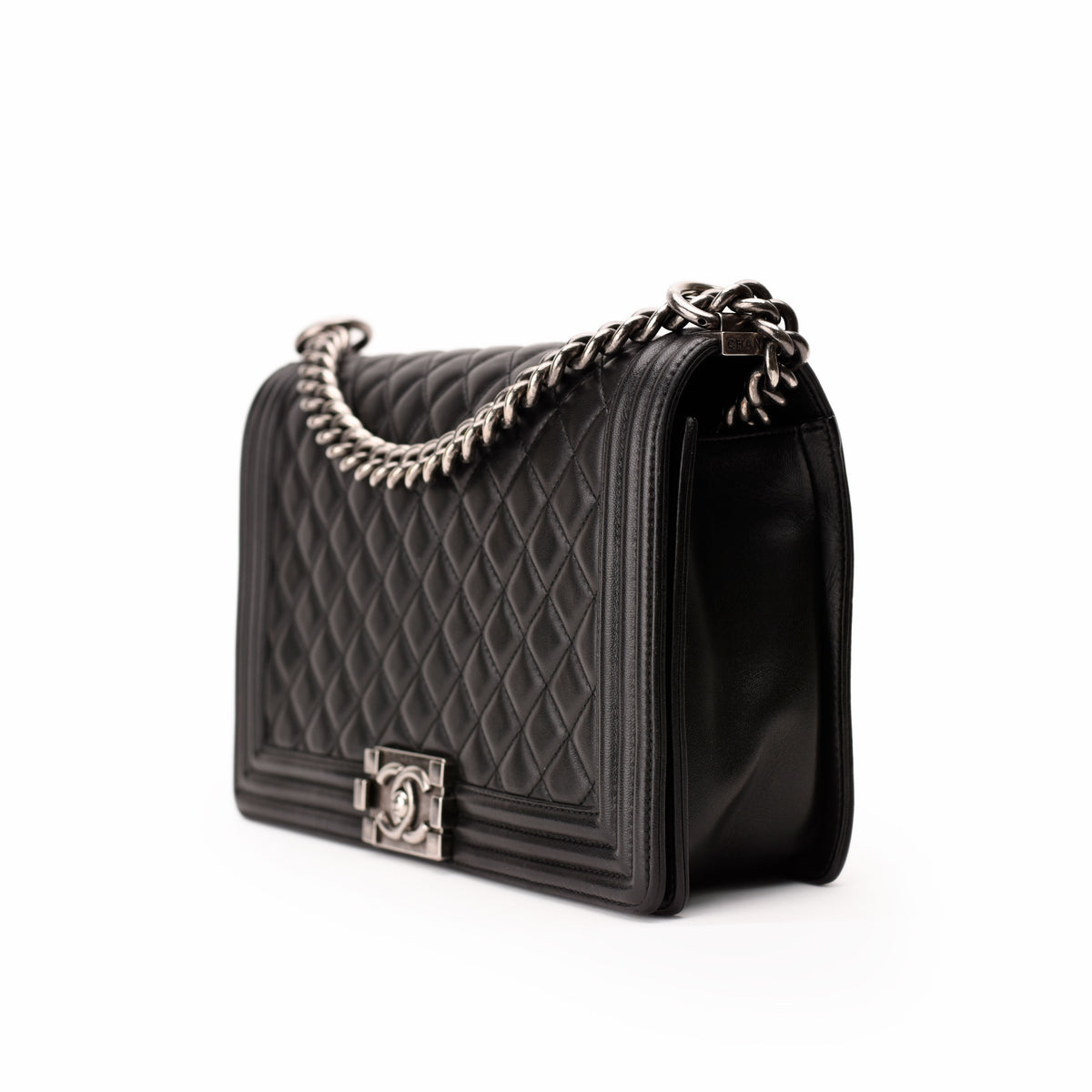 Black quilted leather Chanel handbag with silver chain strap, curated Pre-loved Luxury by Myluxe in Helsinki.