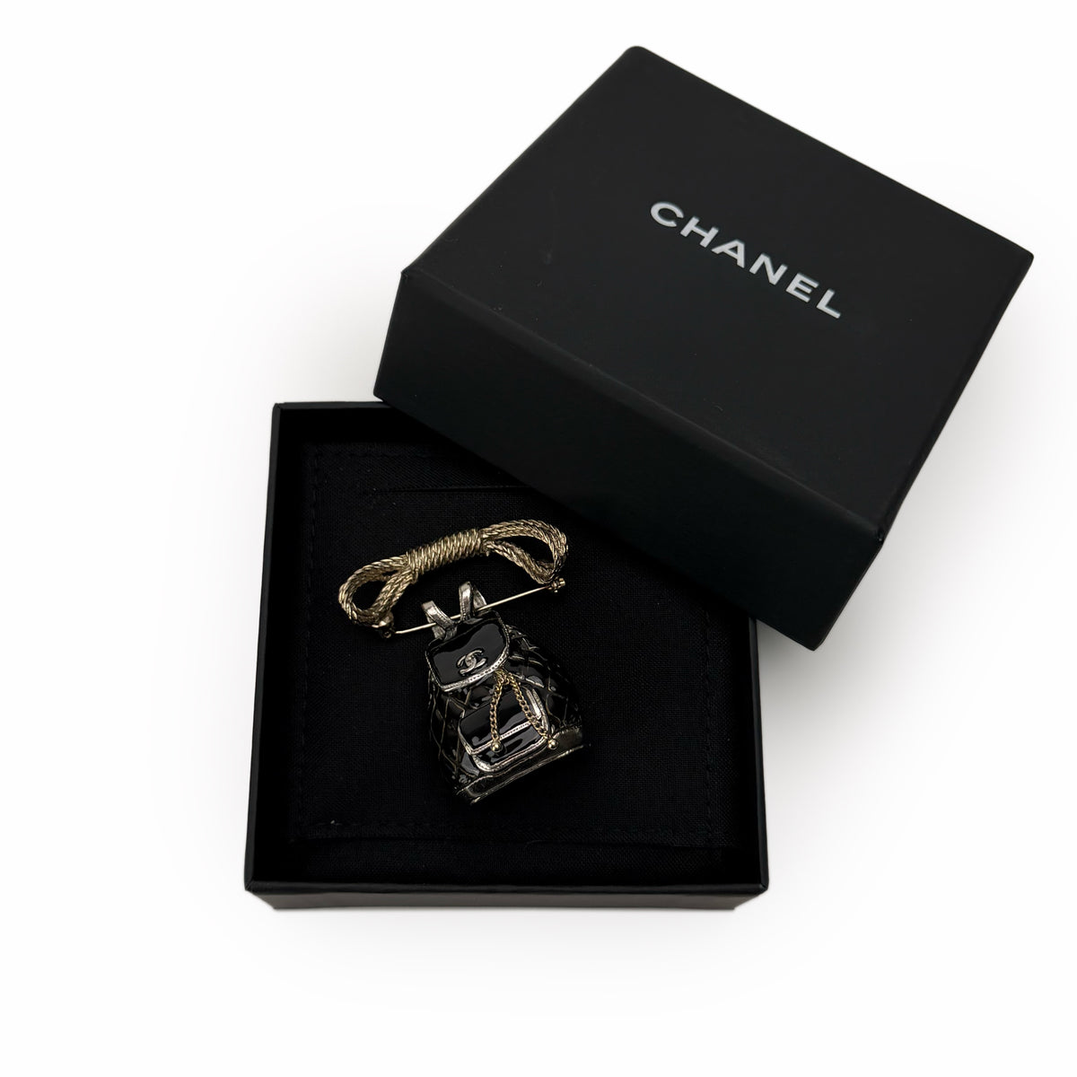 Chanel gold-tone metal and black enamel handbag brooch, curated Pre-loved Luxury by Myluxe in Helsinki.