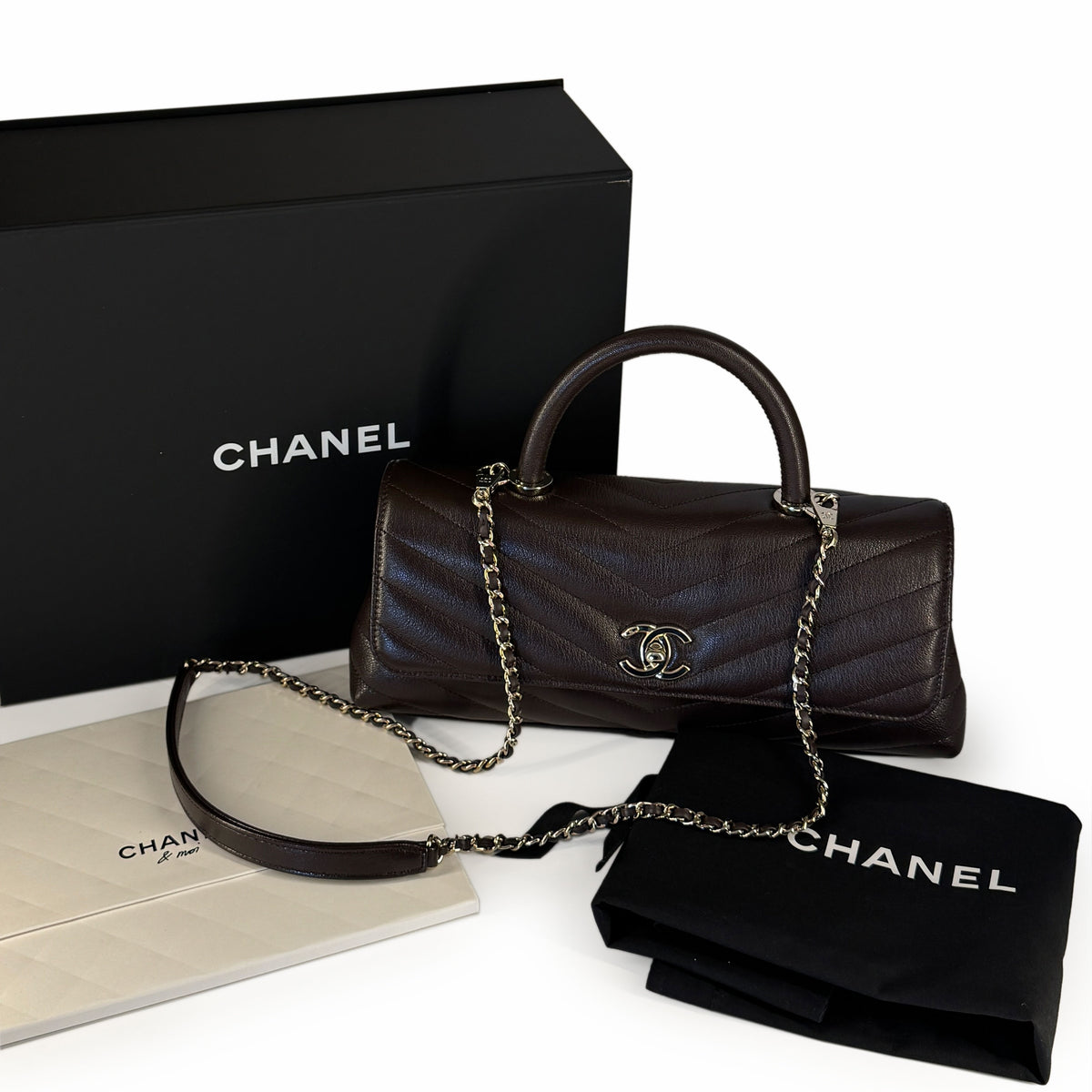 Dark brown quilted leather Chanel handbag with silver chain strap, curated Pre-loved Luxury by Myluxe in Helsinki.