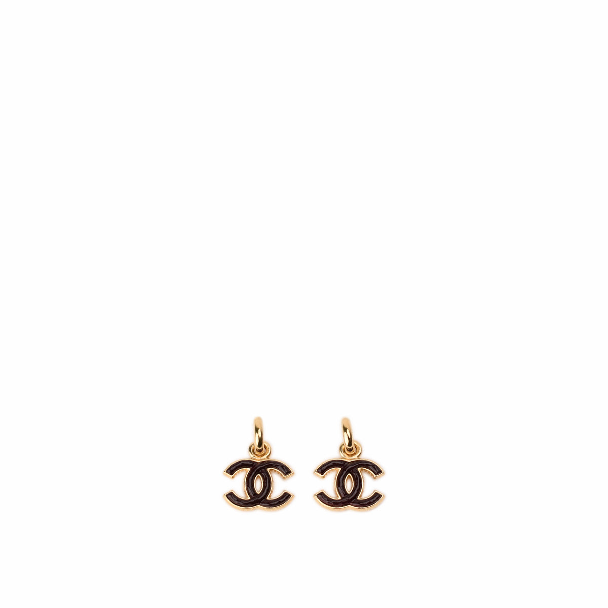 Gold-tone Chanel double C logo earrings with black enamel detailing, curated Pre-loved Luxury by Myluxe in Helsinki.