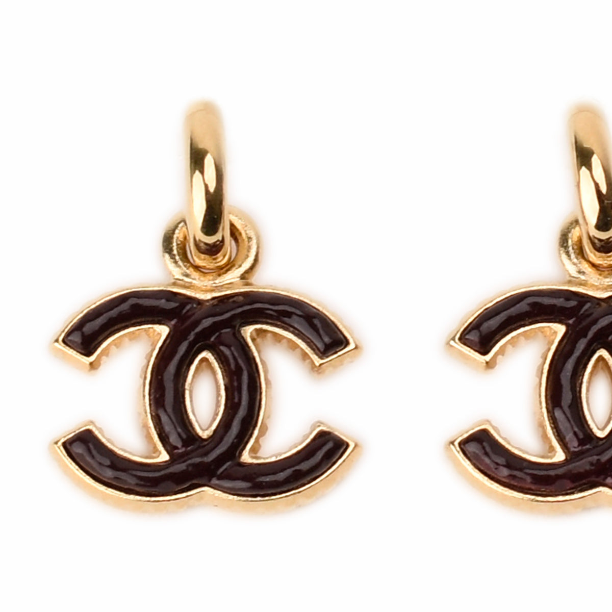 Gold-tone Chanel double C logo earrings with dark brown enamel, curated Pre-loved Luxury by Myluxe in Helsinki.