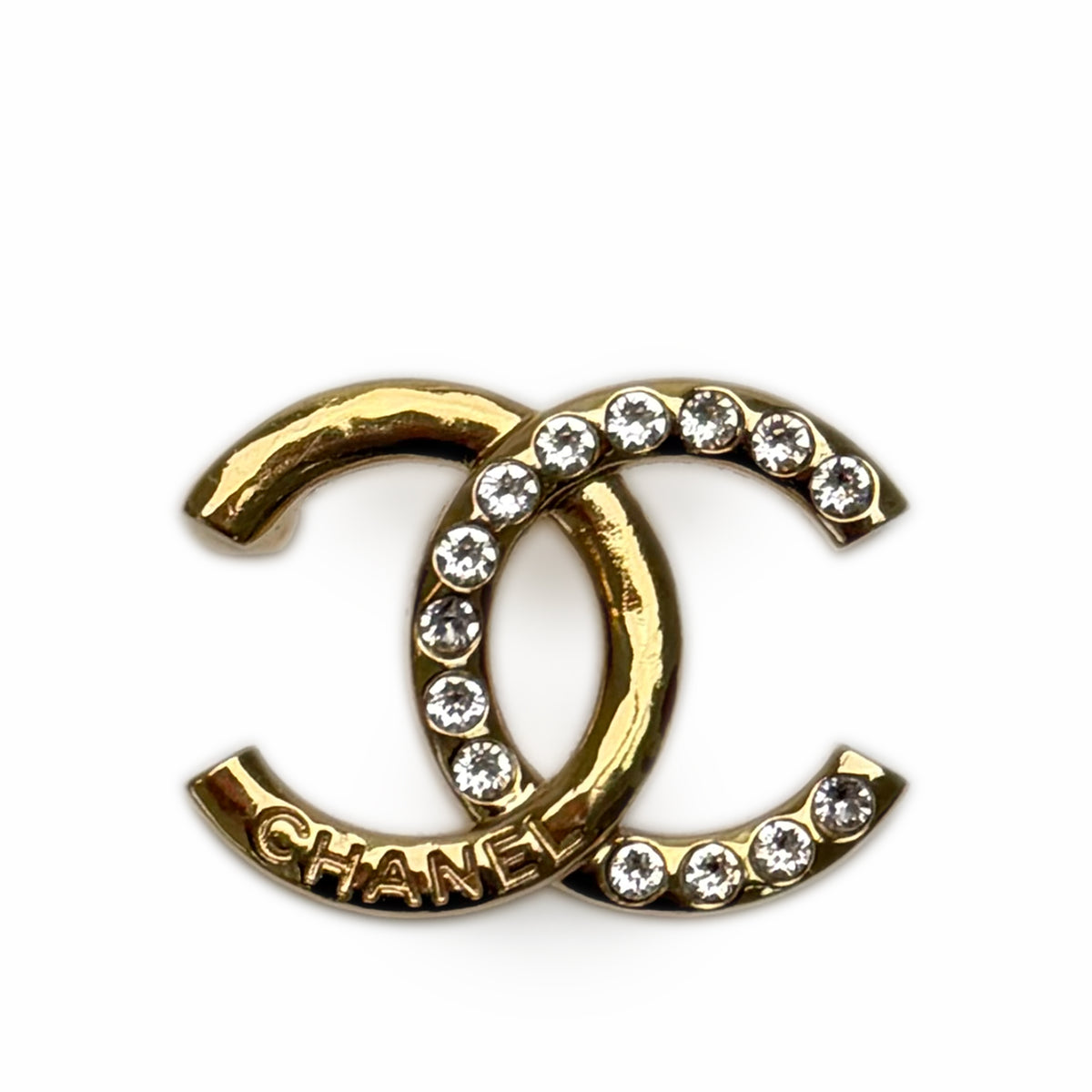 Gold-tone Chanel interlocking CC logo brooch with sparkling crystals, curated Pre-loved Luxury by Myluxe in Helsinki.