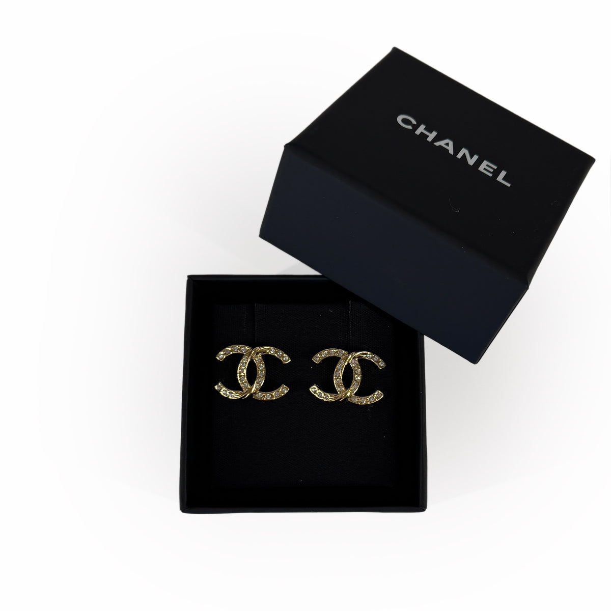 Gold-tone Chanel double C logo earrings in a black designer box, curated Pre-loved Luxury by Myluxe in Helsinki.