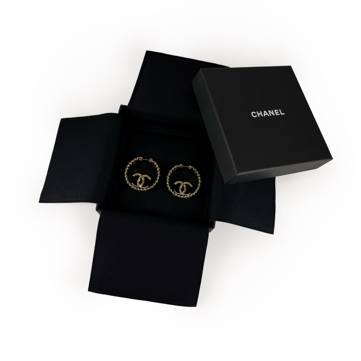 Gold-tone Chanel CC logo hoop earrings in a black gift box, curated Pre-loved Luxury by Myluxe in Helsinki.