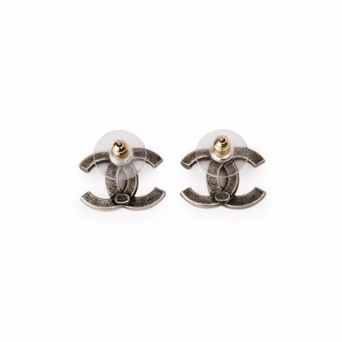 Silver-toned Chanel interlocking CC stud earrings, curated Pre-loved Luxury by Myluxe in Helsinki.
