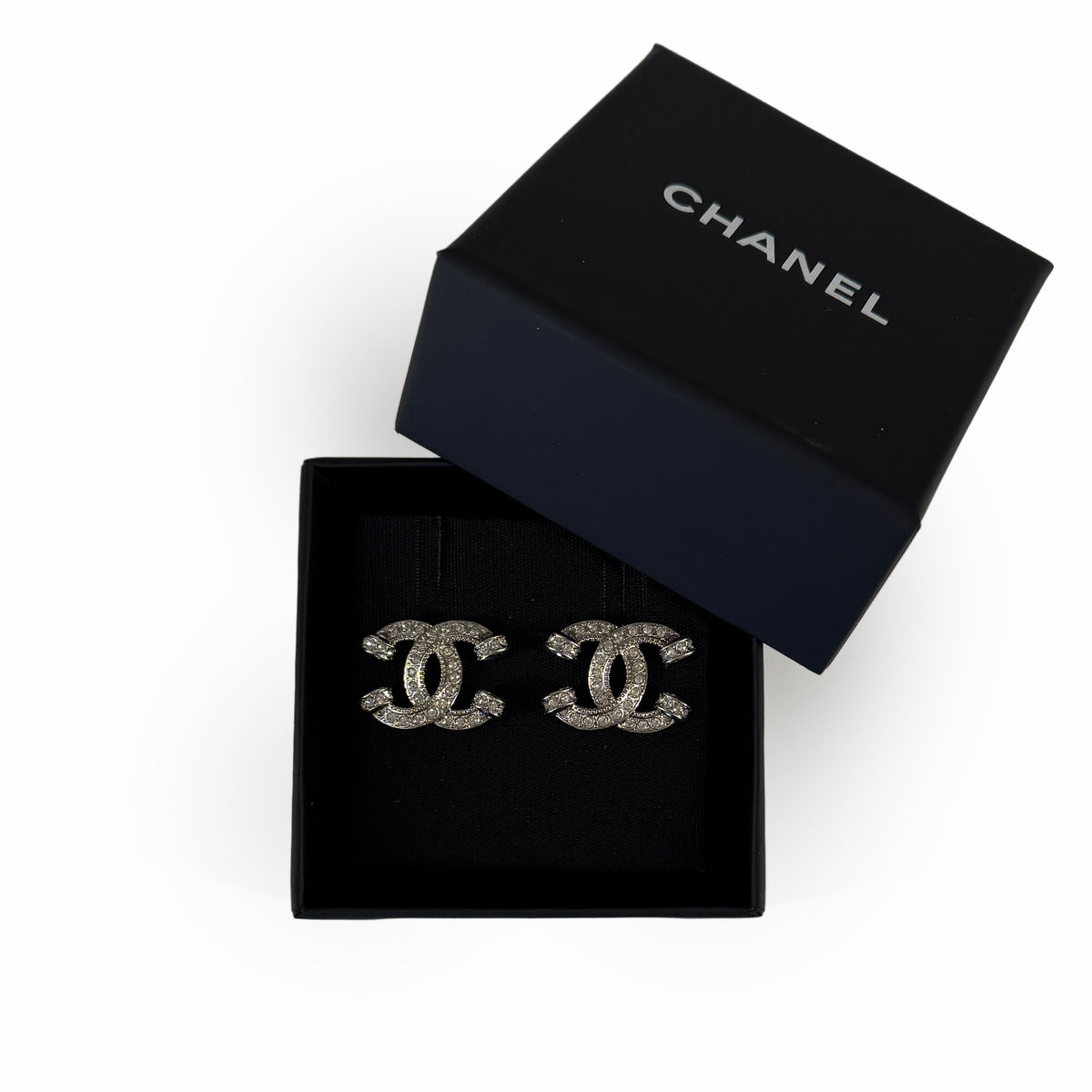 Chanel silver-tone crystal interlocking CC stud earrings in a black Chanel box, curated Pre-loved Luxury by Myluxe in Helsinki.