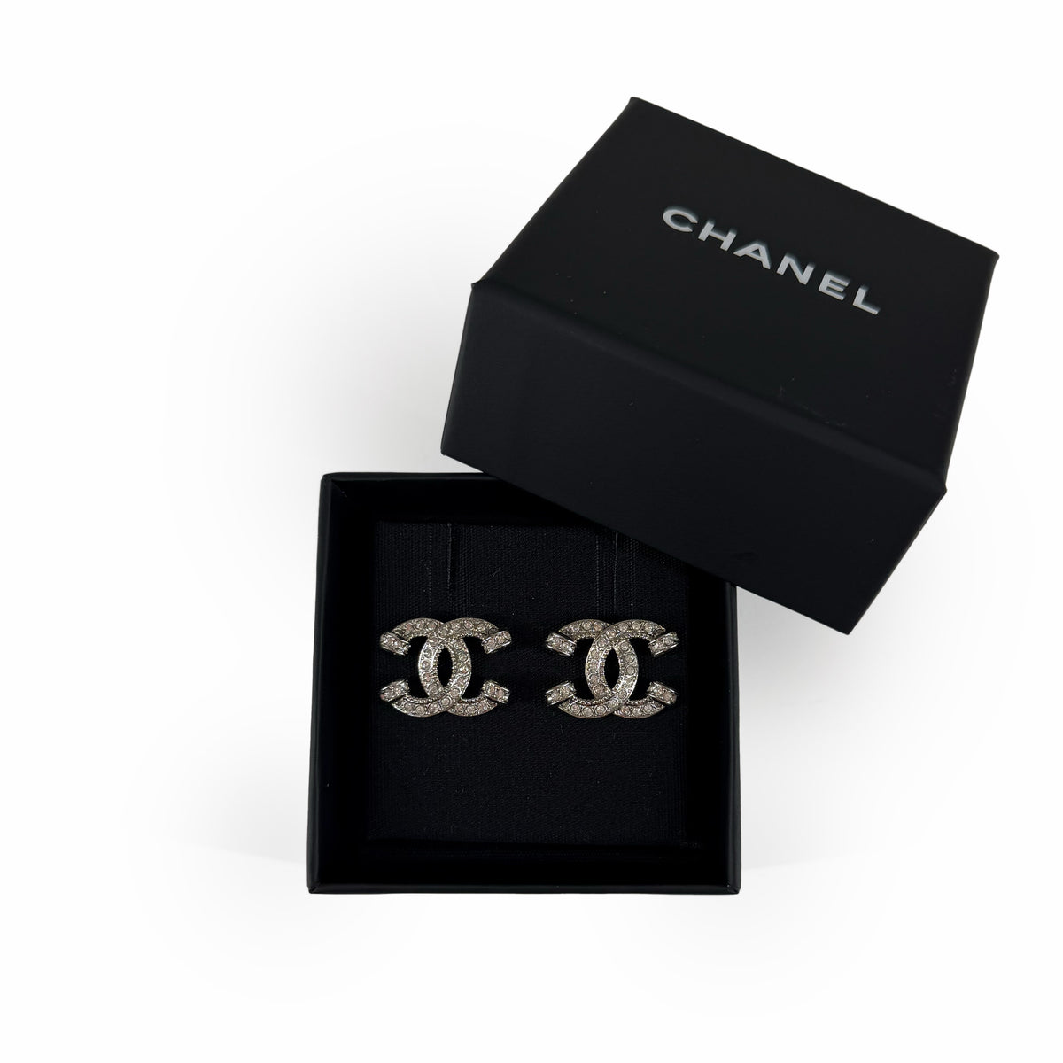 Chanel interlocking CC logo crystal earrings in a black gift box, curated Pre-loved Luxury by Myluxe in Helsinki.