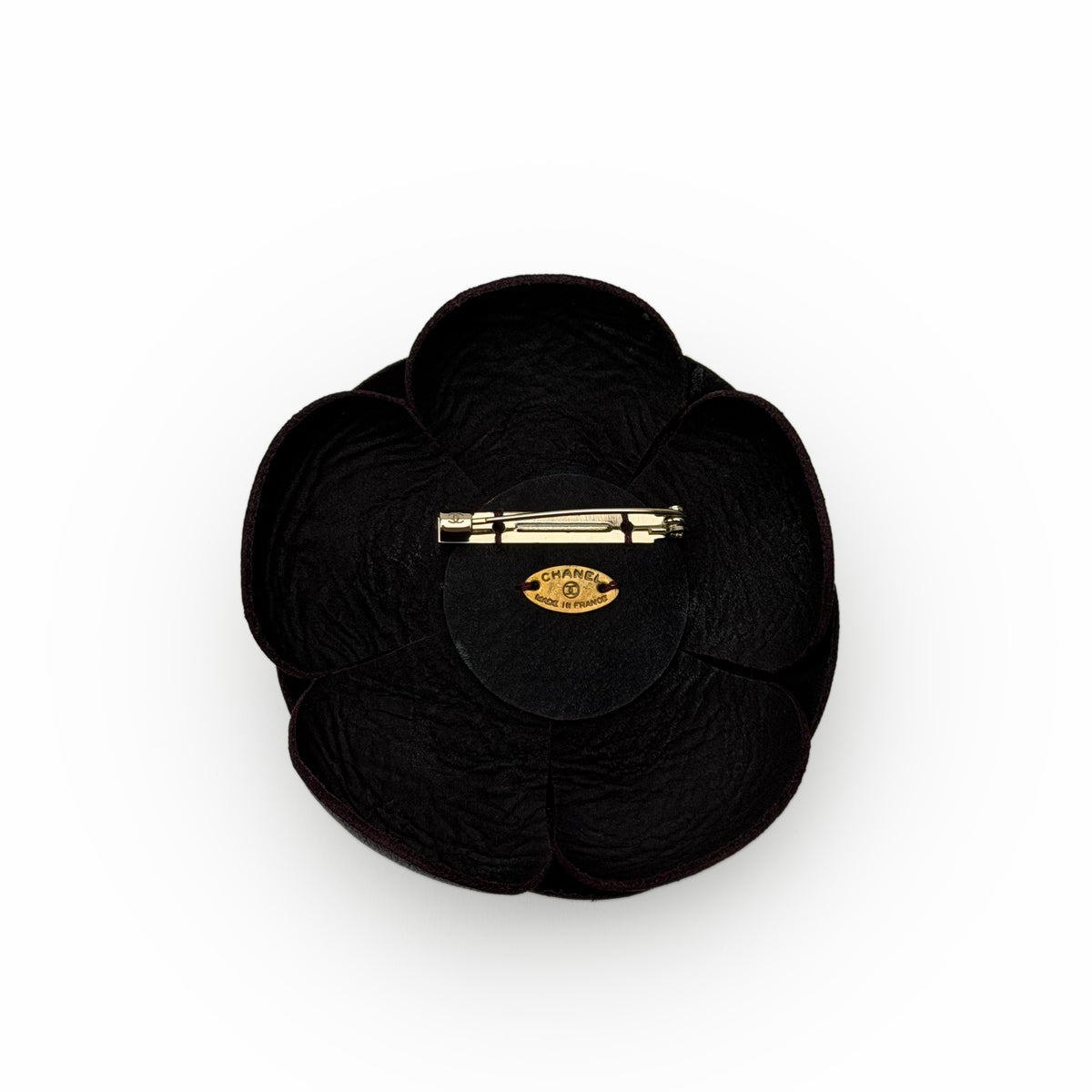 Chanel black velvet flower brooch with gold-tone metal pin, curated Pre-loved Luxury by Myluxe in Helsinki.