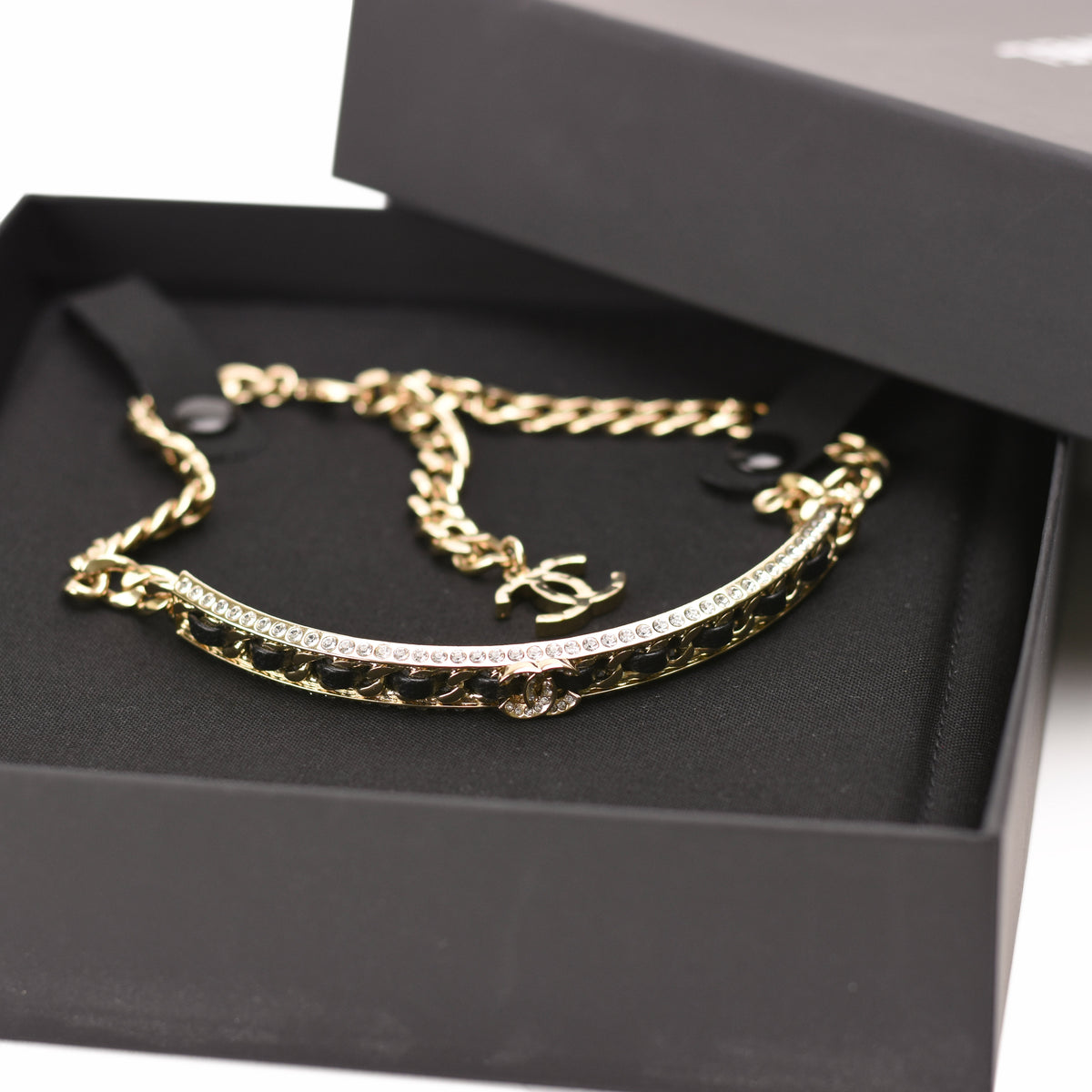 Gold-tone Chanel chain bracelet with black enamel and crystal embellishments, curated Pre-loved Luxury by Myluxe in Helsinki.