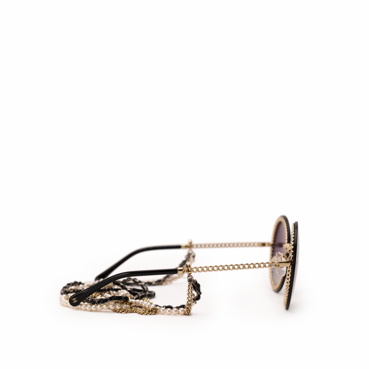 Chanel round black sunglasses with gold-tone chain and pearl detail, curated Pre-loved Luxury by Myluxe in Helsinki.