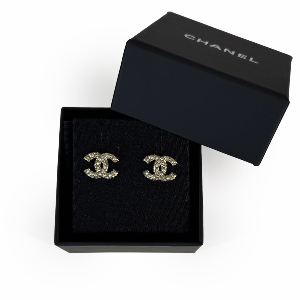 Chanel gold-tone crystal CC logo stud earrings in a black gift box, curated Pre-loved Luxury by Myluxe in Helsinki.