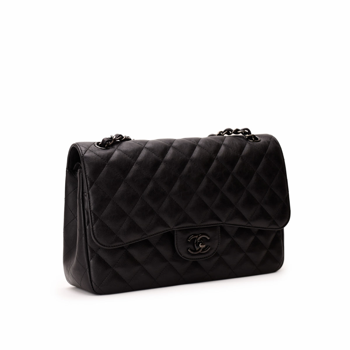 Black quilted leather Chanel flap bag with chain strap. curated Pre-loved Luxury by Myluxe in Helsinki.