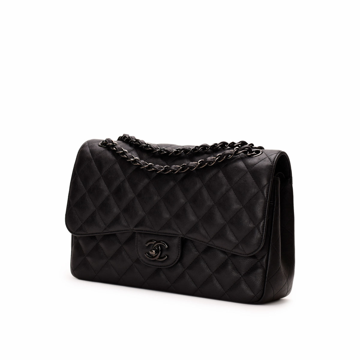 Black quilted leather Chanel flap bag with chain strap. Curated Pre-loved Luxury by Myluxe in Helsinki.