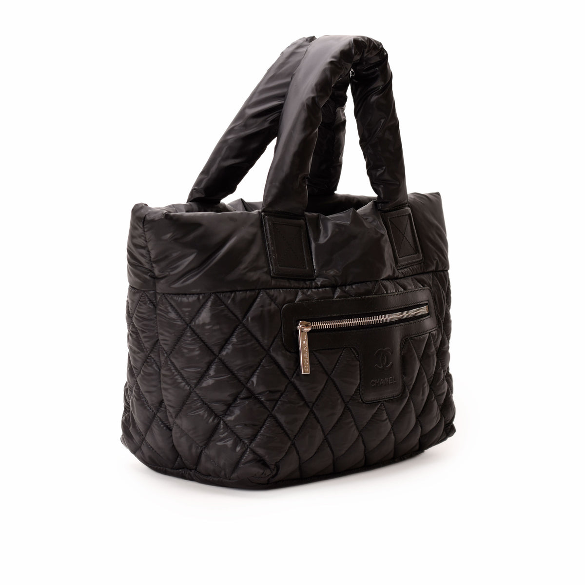 Black quilted nylon Chanel handbag with top handles and zipper pocket, curated Pre-loved Luxury by Myluxe in Helsinki.