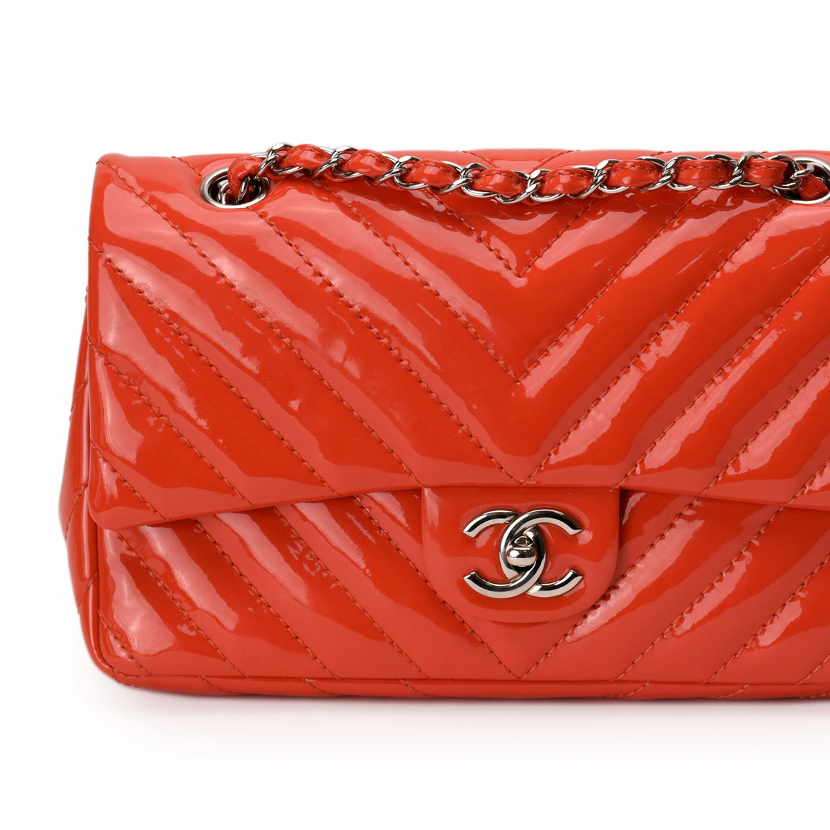 Red patent leather Chanel chevron quilted handbag with silver chain strap, curated Pre-loved Luxury by Myluxe in Helsinki.