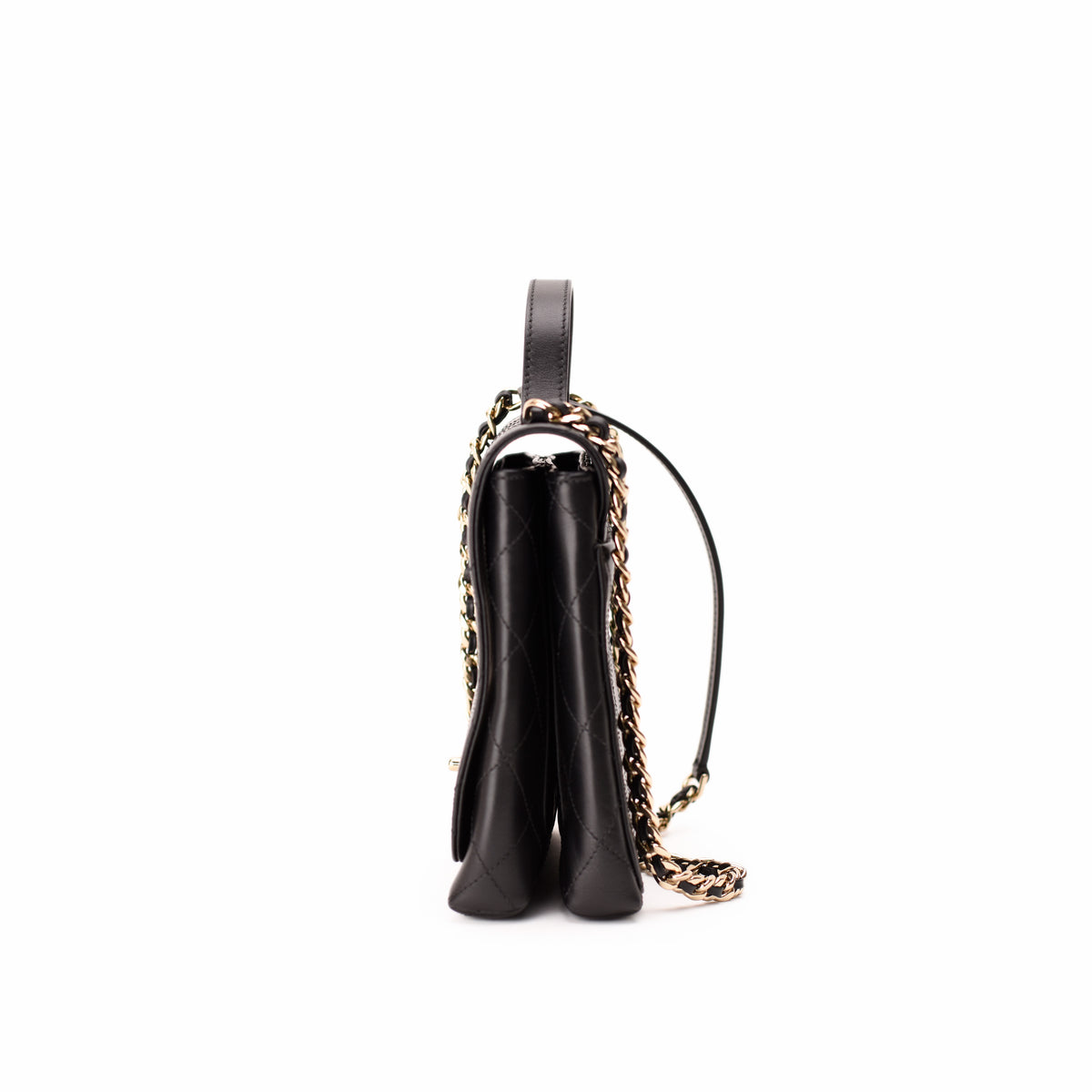 Side view of a black quilted leather handbag with a gold-tone chain strap, curated Pre-loved Luxury by Myluxe in Helsinki.