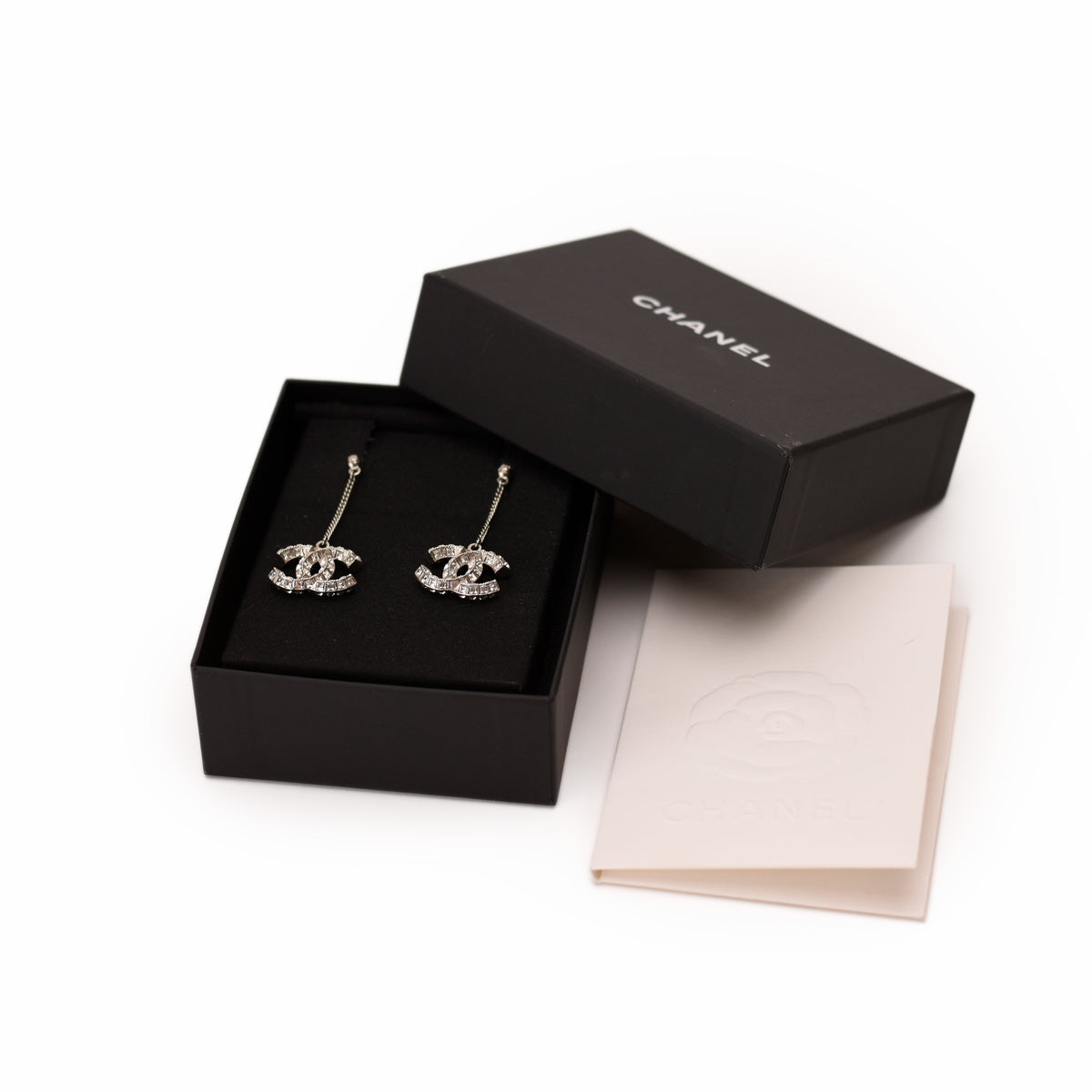 Chanel silver-tone crystal CC logo drop earrings in original box. curated Pre-loved Luxury by Myluxe in Helsinki.