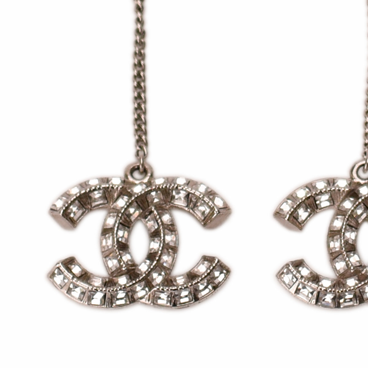 Chanel silver-tone crystal embellished interlocking CC logo earrings. curated Pre-loved Luxury by Myluxe in Helsinki.