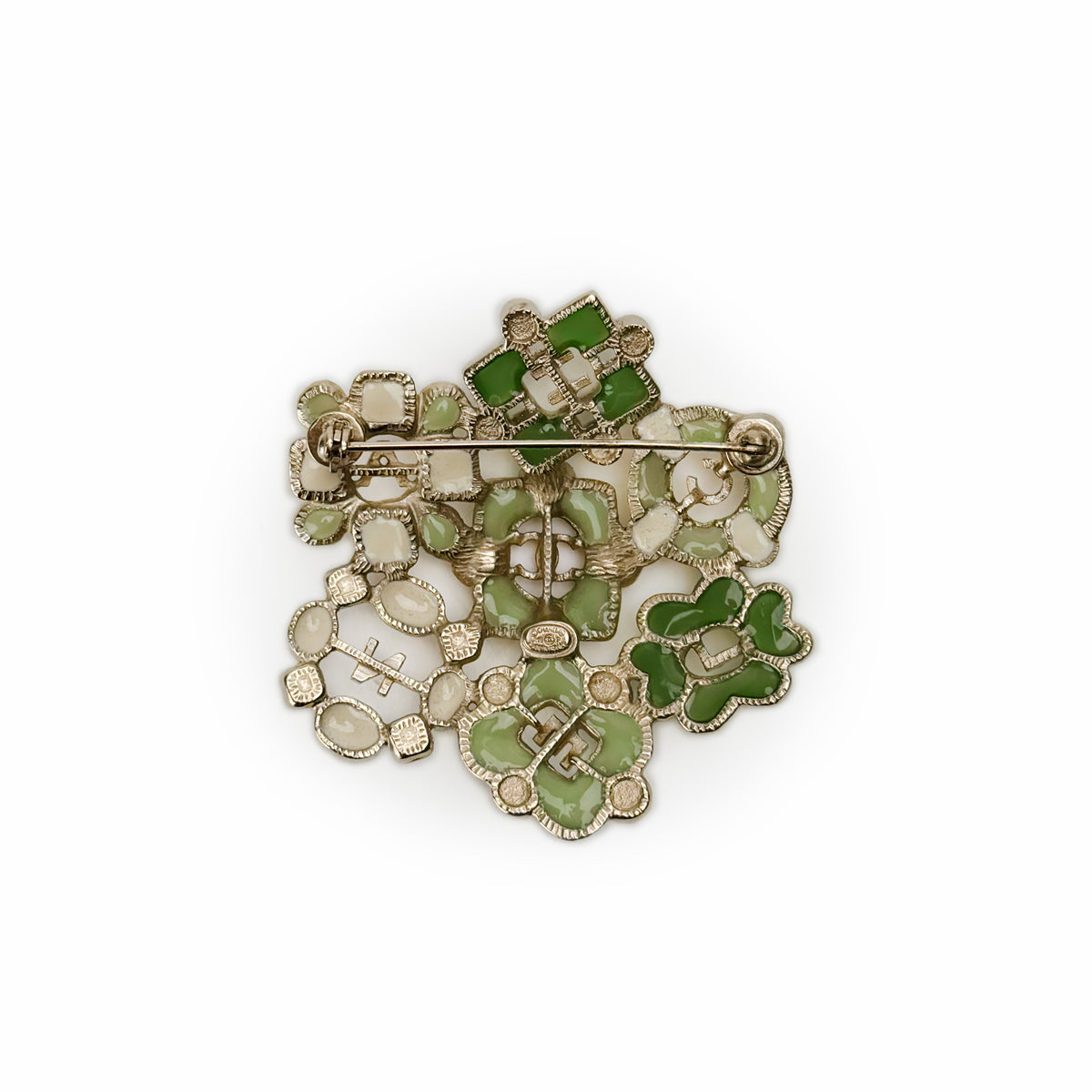 Floral gold-tone brooch with green enamel and white stone accents, curated Pre-loved Luxury by Myluxe in Helsinki.