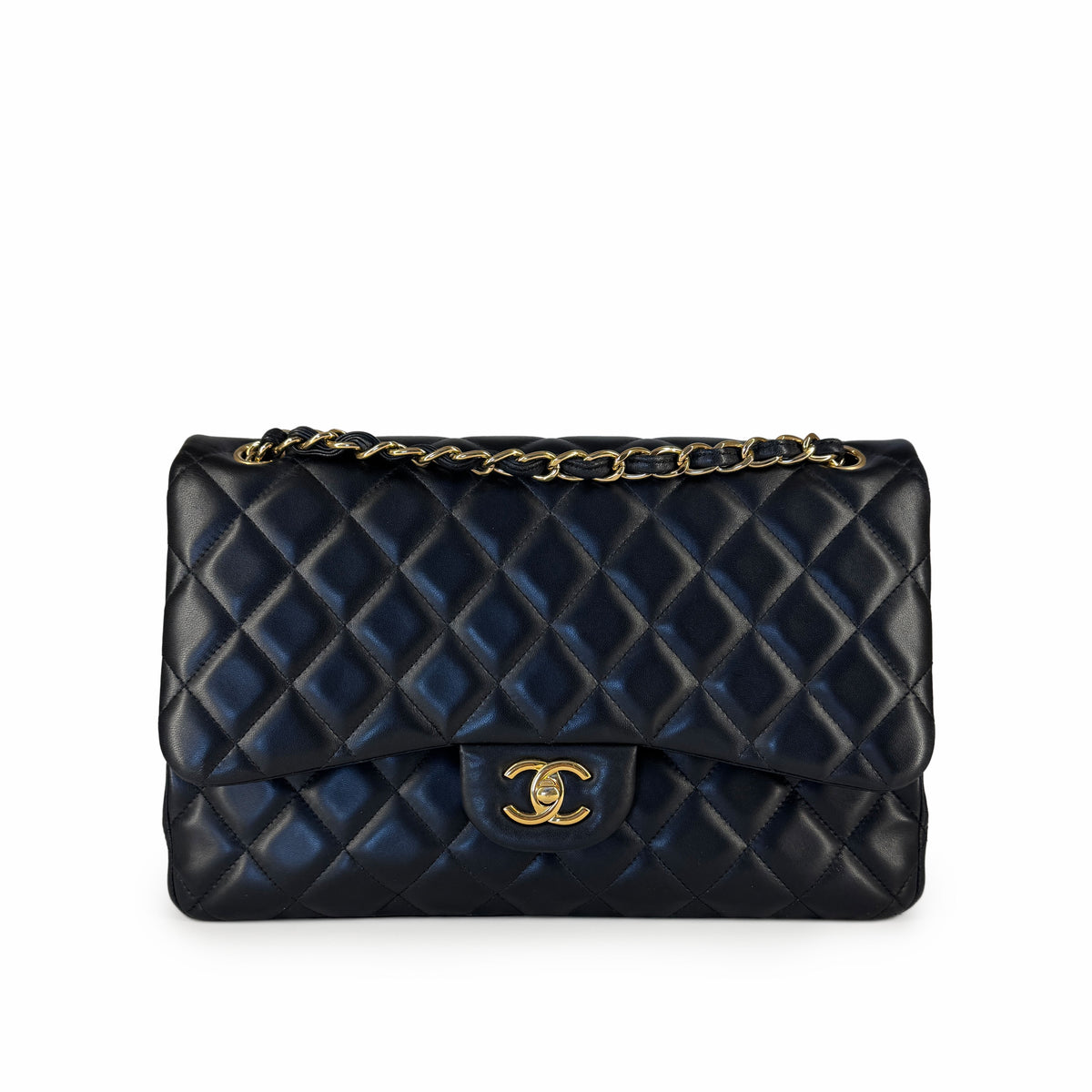 Black quilted lambskin Chanel flap bag with gold-tone chain strap, curated Pre-loved Luxury by Myluxe in Helsinki.