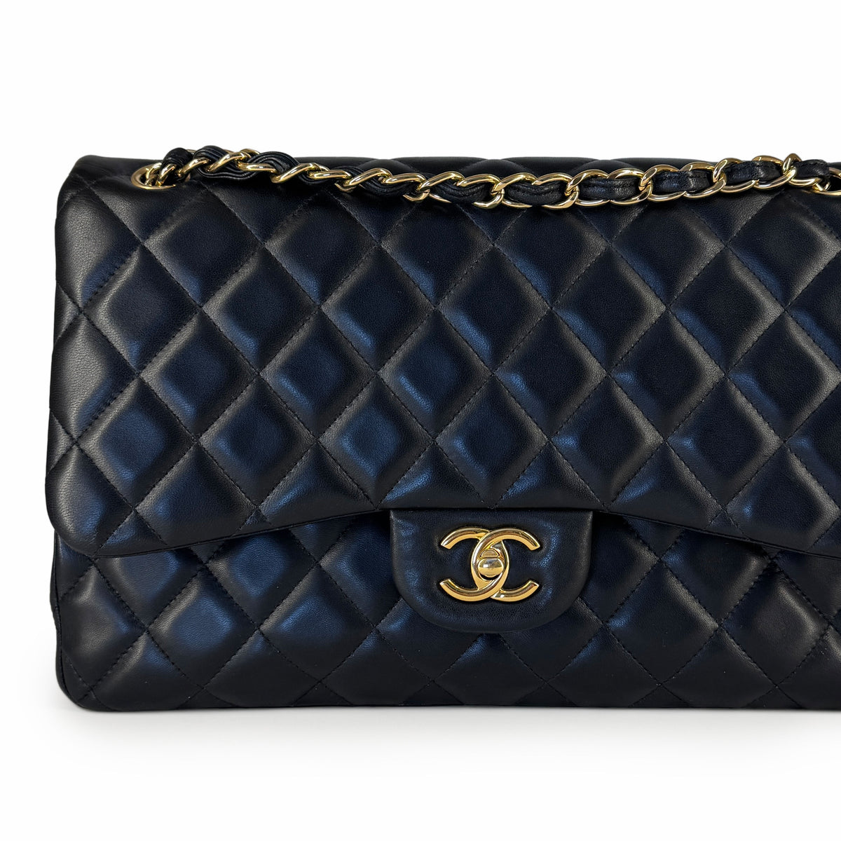 Black quilted lambskin Chanel flap bag with gold-tone chain strap, curated Pre-loved Luxury by Myluxe in Helsinki.