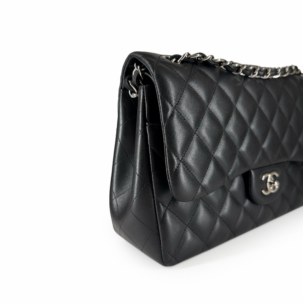 Black quilted lambskin leather Chanel flap bag with silver chain strap, curated Pre-loved Luxury by Myluxe in Helsinki.