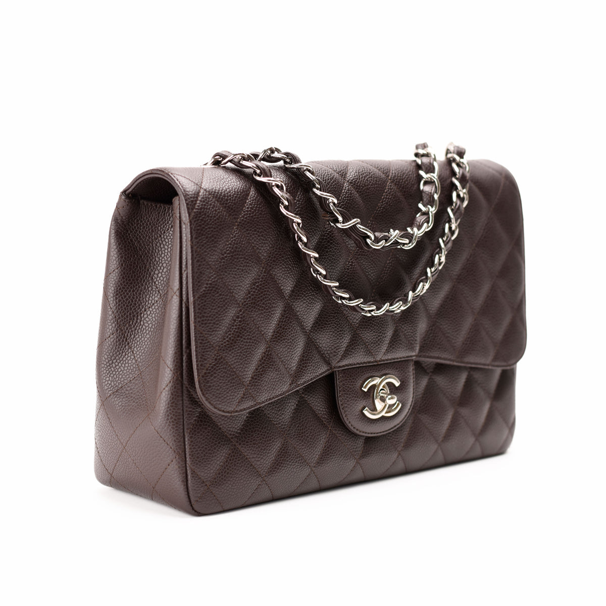 Brown quilted leather Chanel flap bag with silver chain strap, curated Pre-loved Luxury by Myluxe in Helsinki.