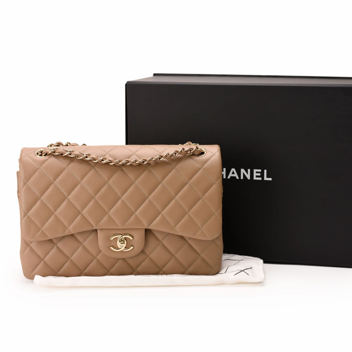Beige quilted leather Chanel flap bag with gold chain strap, curated Pre-loved Luxury by Myluxe in Helsinki.