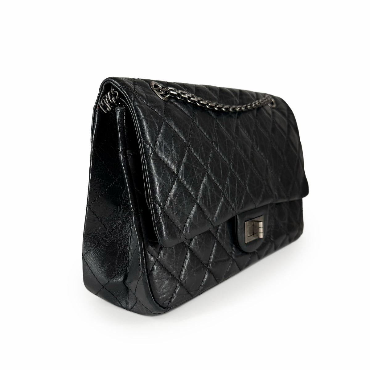 Black quilted leather flap handbag with silver chain strap, curated Pre-loved Luxury by Myluxe in Helsinki.