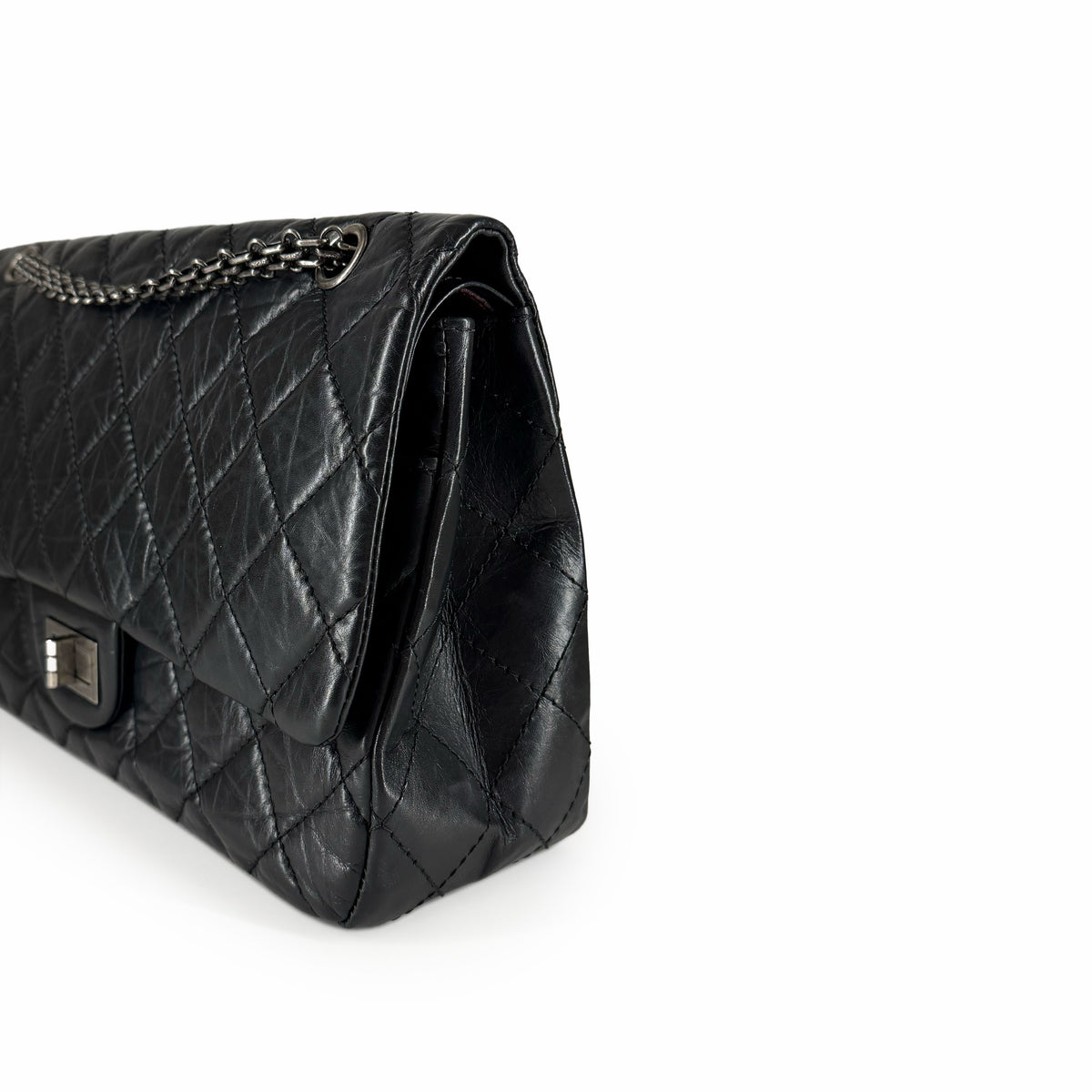 Black quilted leather handbag with silver chain strap, curated Pre-loved Luxury by Myluxe in Helsinki.