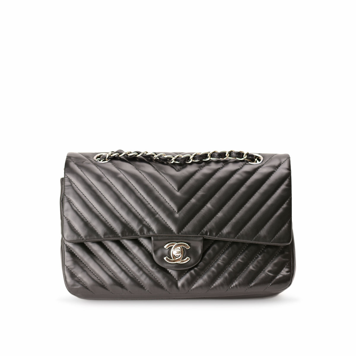 Black quilted leather Chanel flap bag with silver chain strap. curated Pre-loved Luxury by Myluxe in Helsinki.