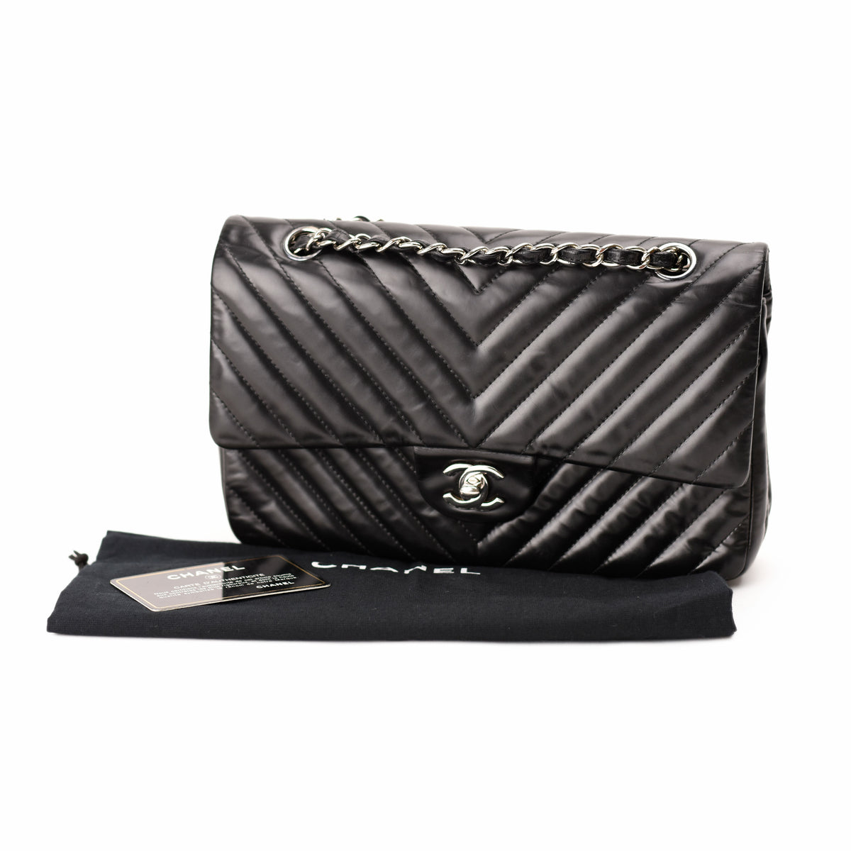Black quilted nylon Chanel flap bag with silver chain strap. curated Pre-loved Luxury by Myluxe in Helsinki.