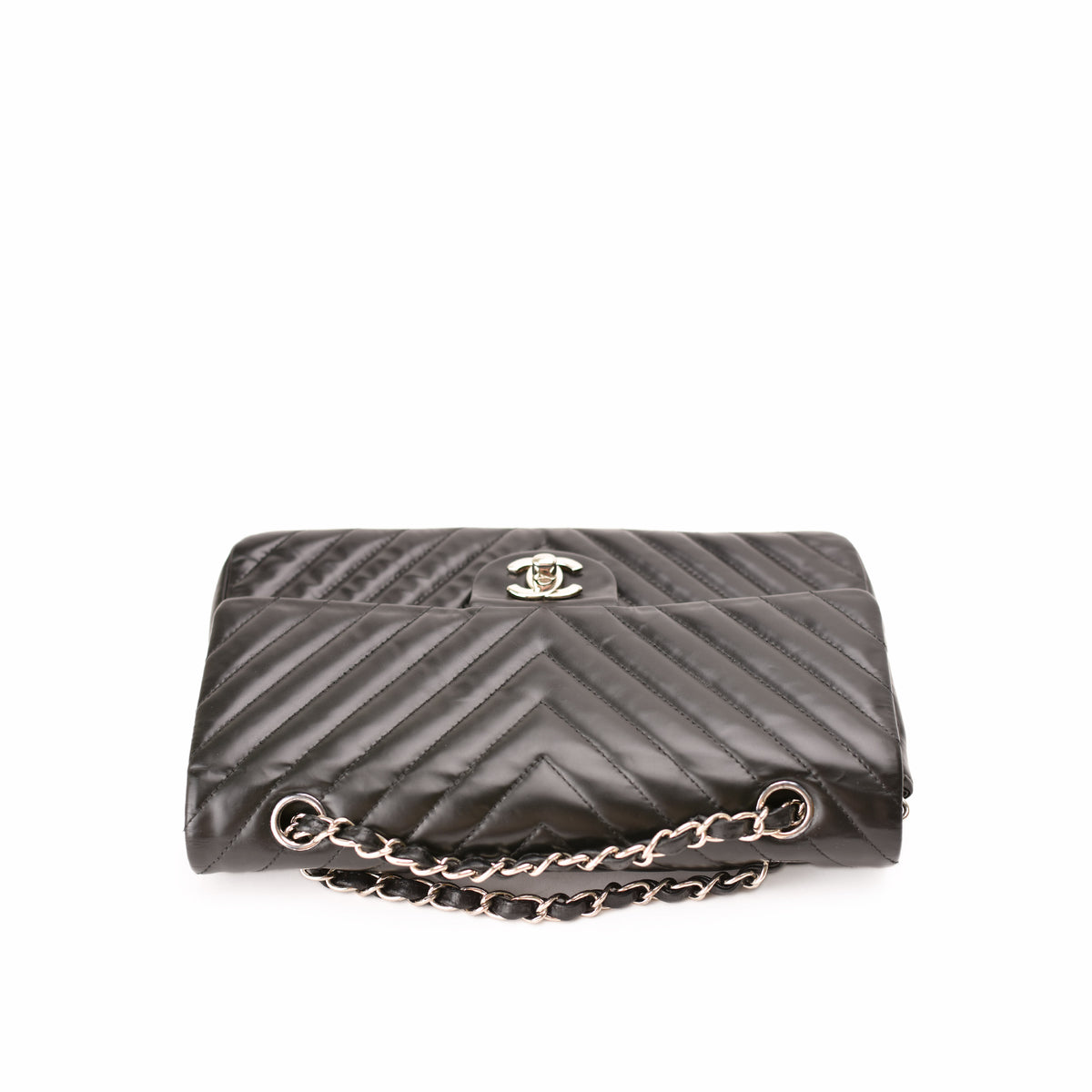 Black quilted satin Chanel flap bag with silver chain strap. curated Pre-loved Luxury by Myluxe in Helsinki.