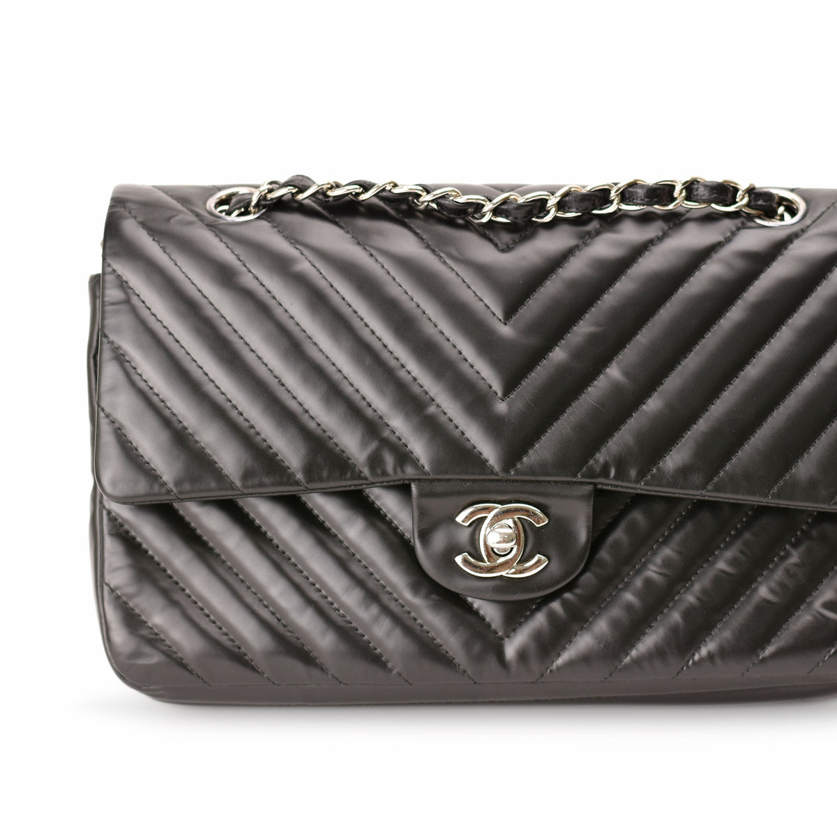 Black quilted lambskin Chanel flap bag with silver chain strap. curated Pre-loved Luxury by Myluxe in Helsinki.