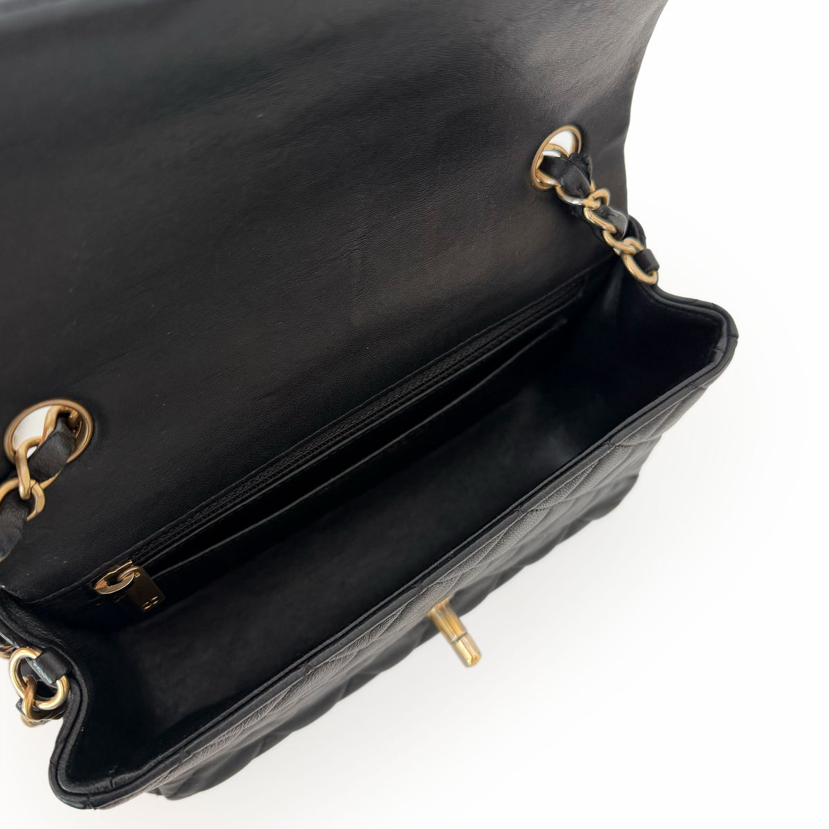 Open black quilted leather handbag with gold-tone chain strap, curated Pre-loved Luxury by Myluxe in Helsinki.