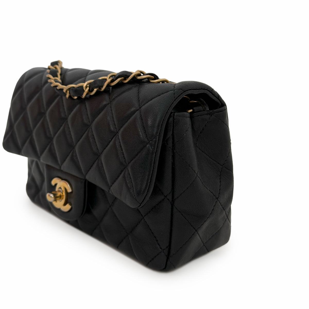 Black quilted lambskin Chanel flap bag with gold-tone chain strap, curated Pre-loved Luxury by Myluxe in Helsinki.